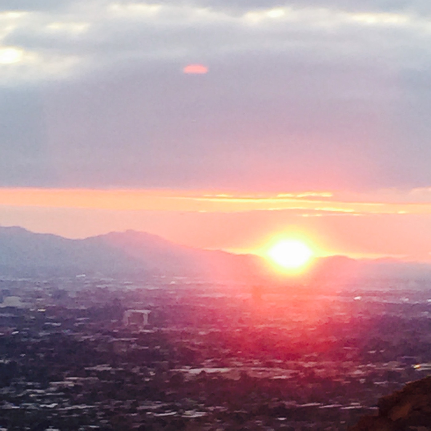 Sunset over the Phoenix skyline and surrounding mountains, photographed by Nicholas Hanley.